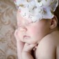 1 month old baby girl with floral headband photographed by little rock newborn photographer
