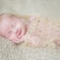 newborn baby girl smiles during her pictures with little rock photographer