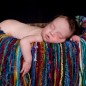 newborn girl sleeps in basket during newborn pictures