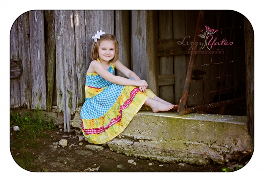 6 year old girl in a barn door during little rock family photography session