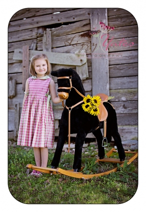 Rockinghorse, sunflowers and a sweet girl during little rock family photography session