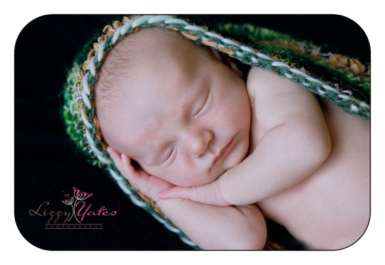 Newborn Pictured in Green Handmade Cacoon during a custom session in Little Rock