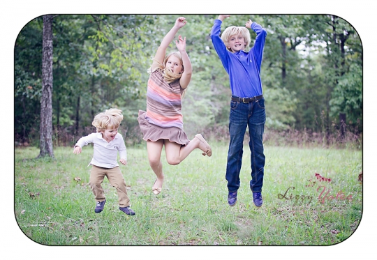 Three little rock kids jump for joy during their pictures