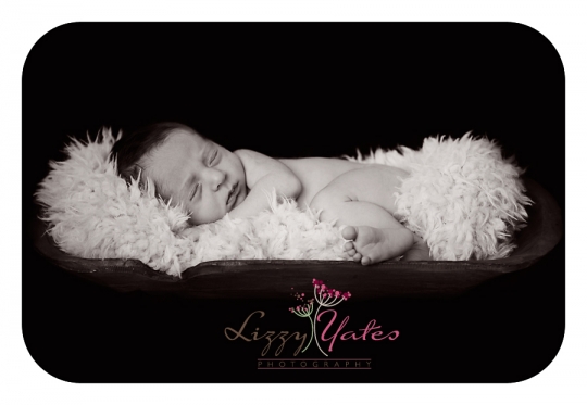 Arkansas newborn photographer captures black and white image of baby boy in a wooden bowl